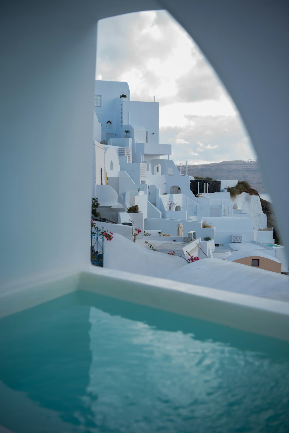 white plastic chairs near swimming pool