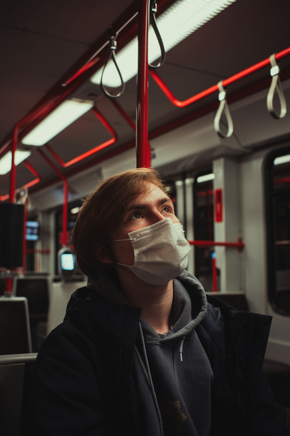 man in black hoodie wearing white face mask