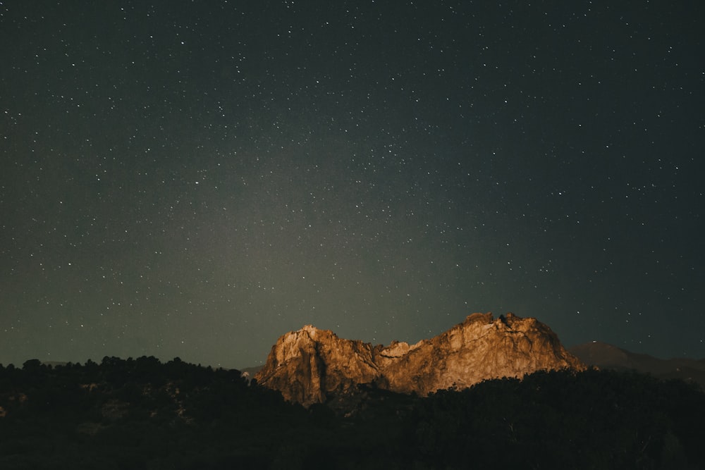 brown mountain under blue sky during night time