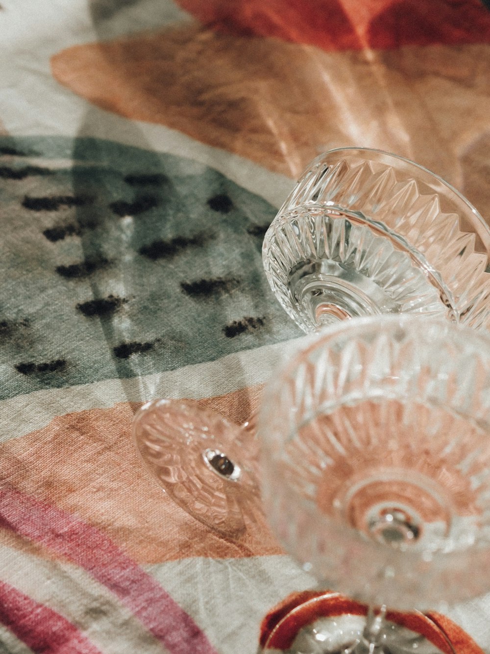 clear cut glass bowl on white and black textile