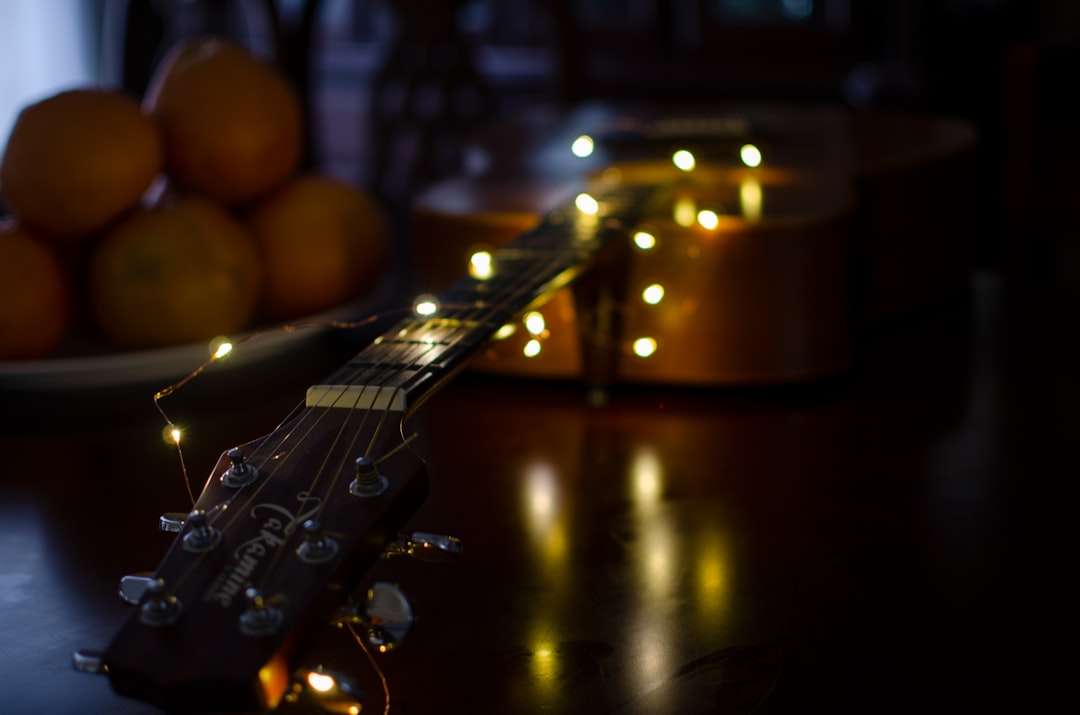 black electric guitar with yellow light bokeh