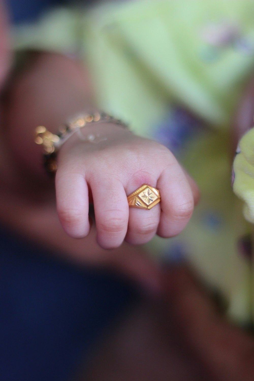 gold diamond ring on persons finger