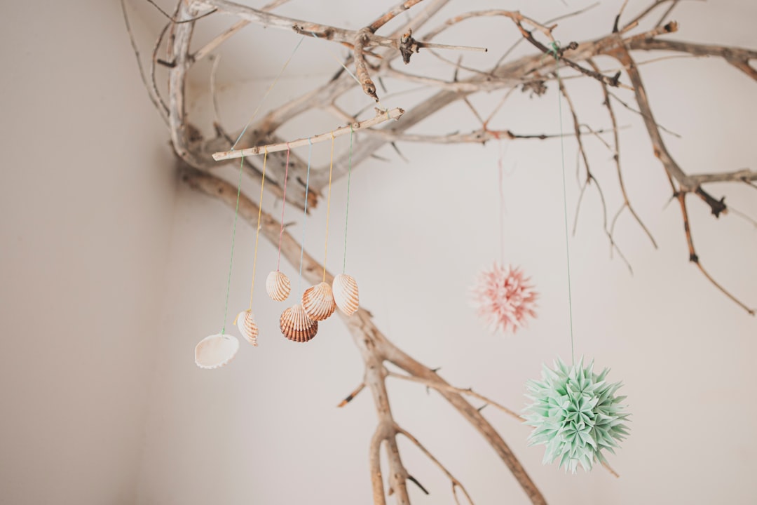 pink and green flowers on brown tree branch