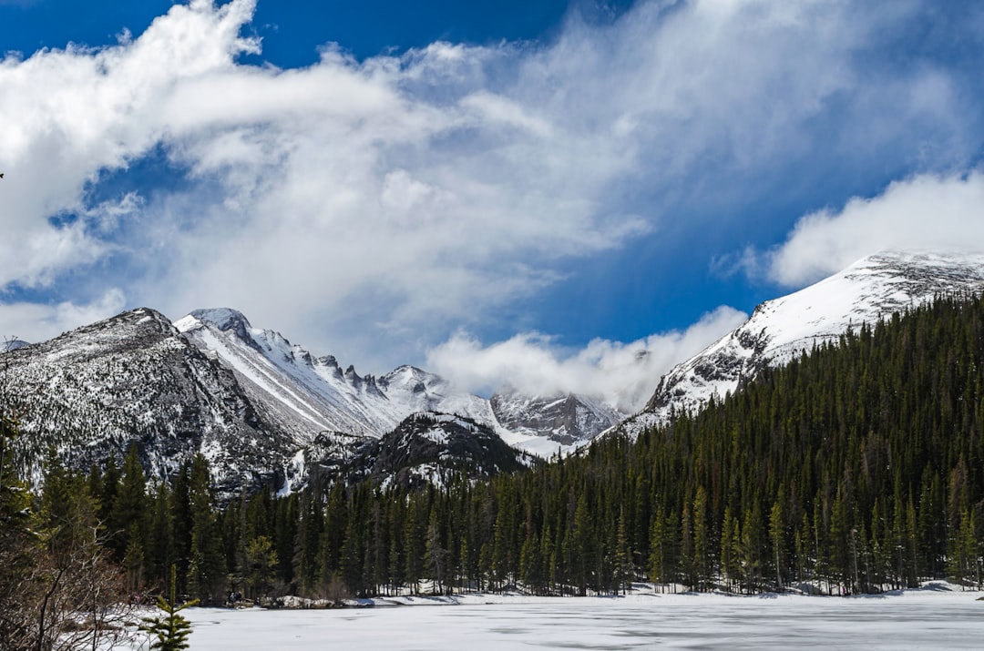 The mountains around Bear Lake in Rocky Mountain National Park in Colorado on a perfect day. The lake is mostly frozen and the views are magnificent.