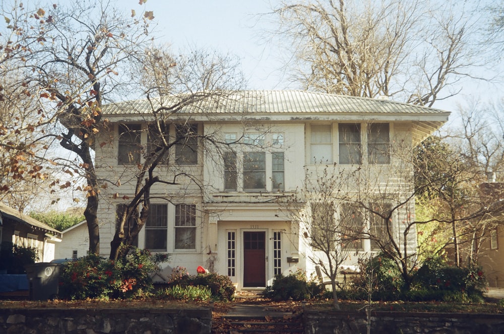 white and brown concrete building near trees during daytime