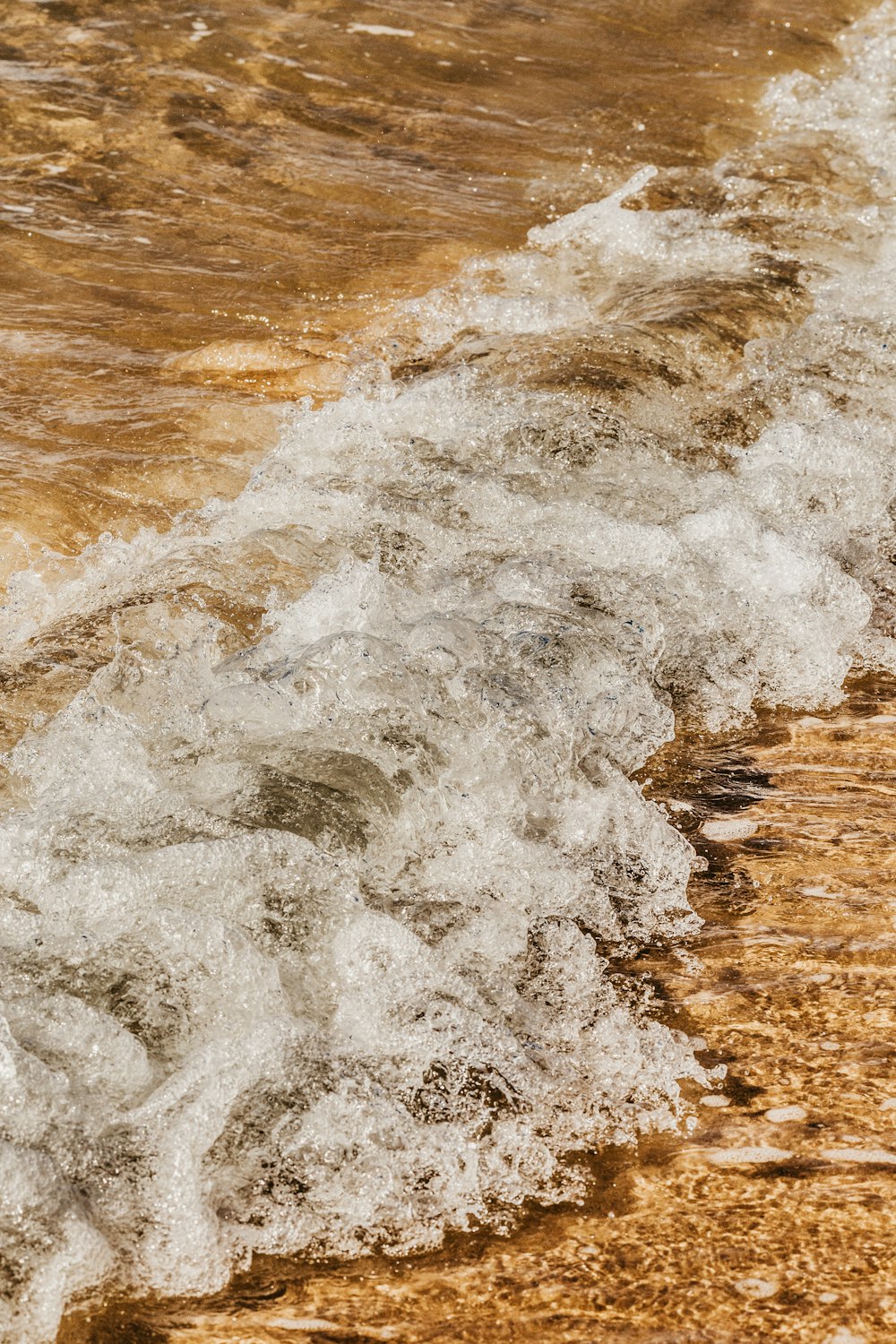 ocean waves crashing on shore during daytime