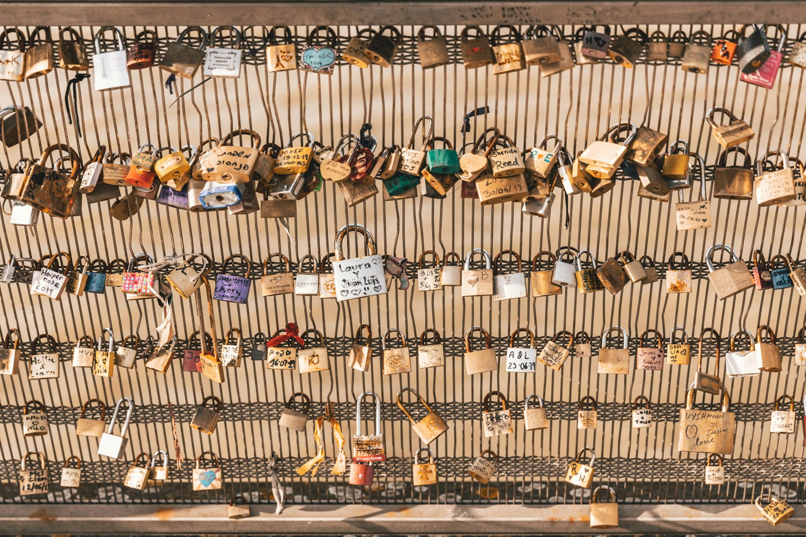 padlocks engraved and attached to bridge in france