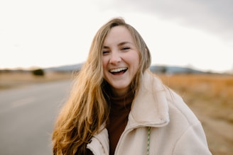 smiling woman in green jacket
