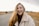 smiling woman in green jacket