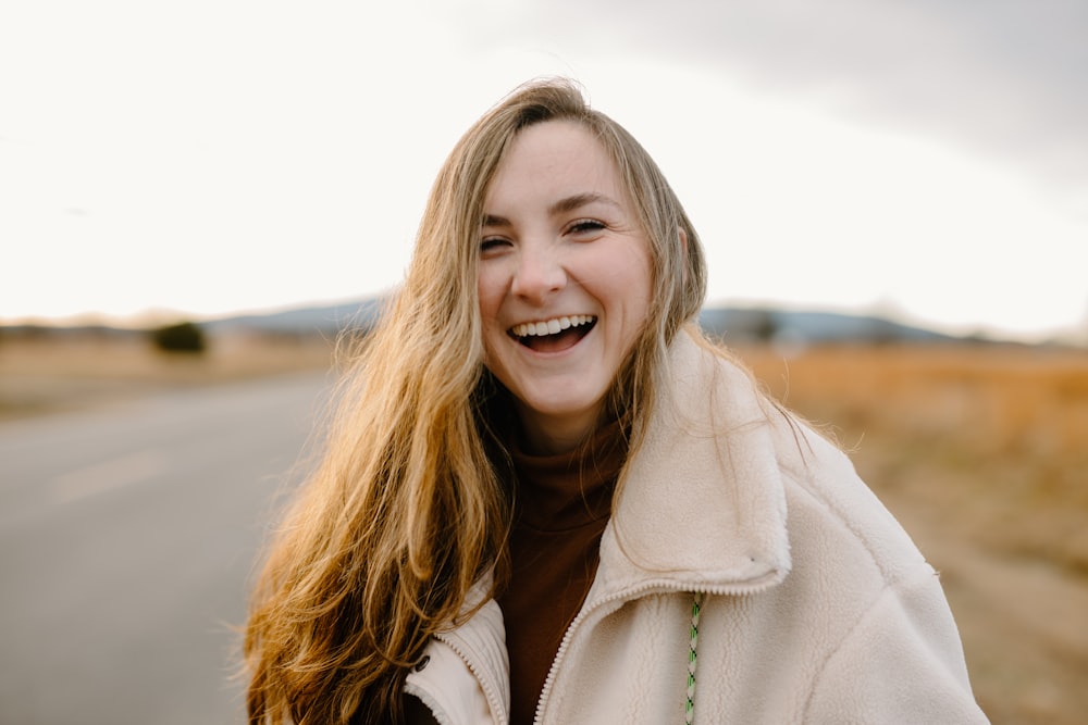 smiling woman in green jacket