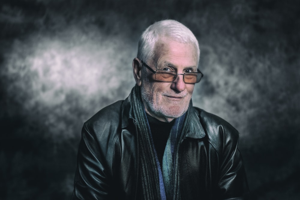 man in black leather jacket wearing black framed eyeglasses