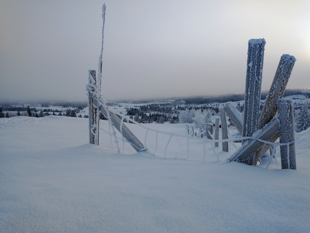 brown wooden bridge on snow covered ground during daytime