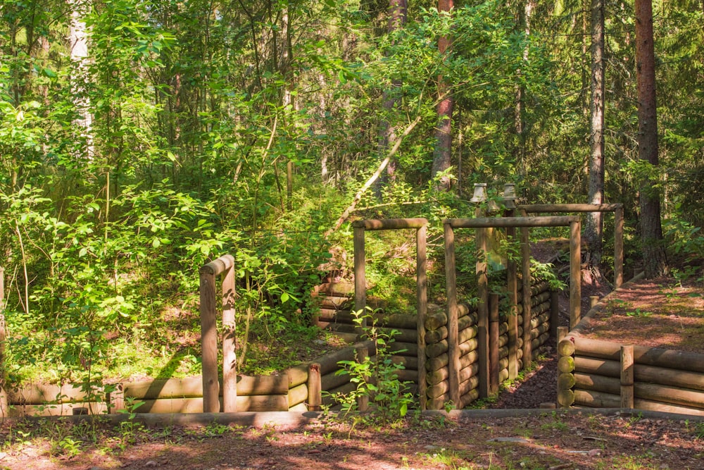 brown wooden fence in forest during daytime