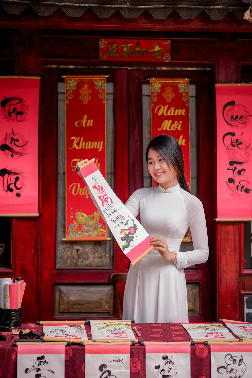 woman in white dress holding white printer paper