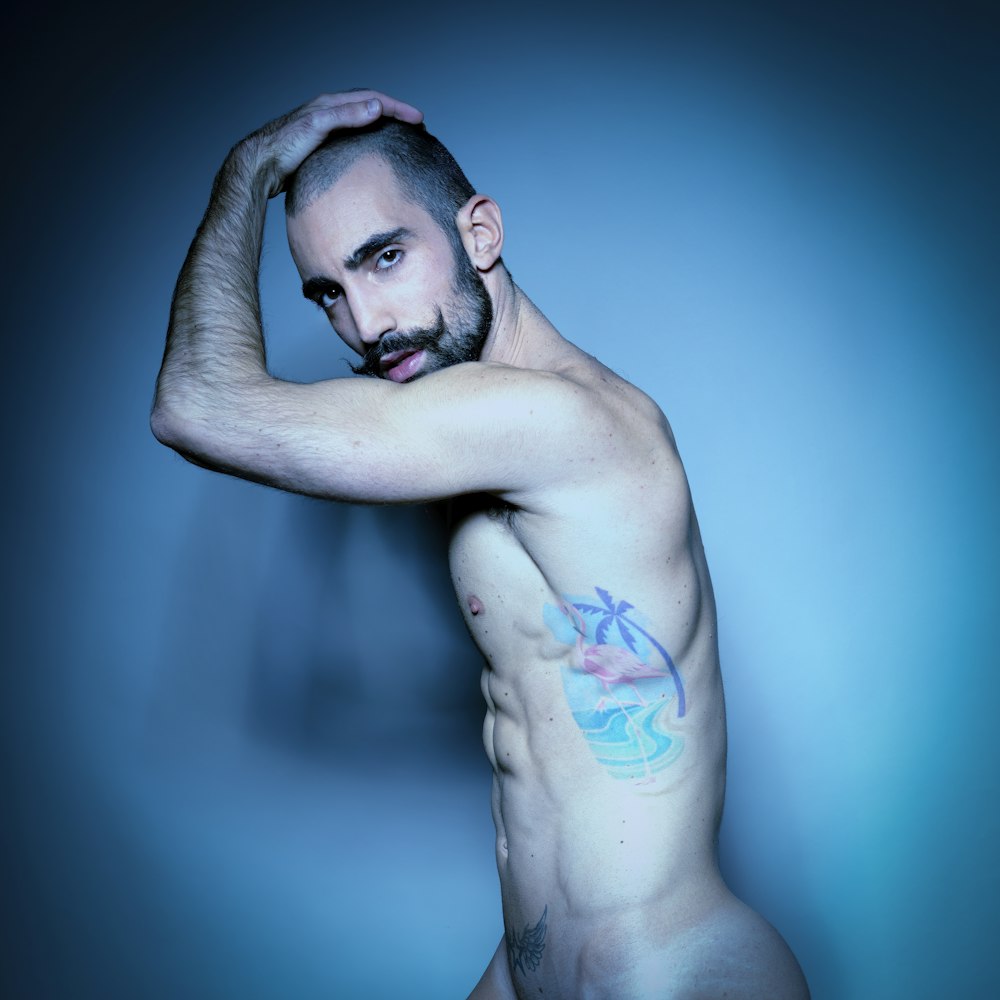 topless man with blue and red paint on his body