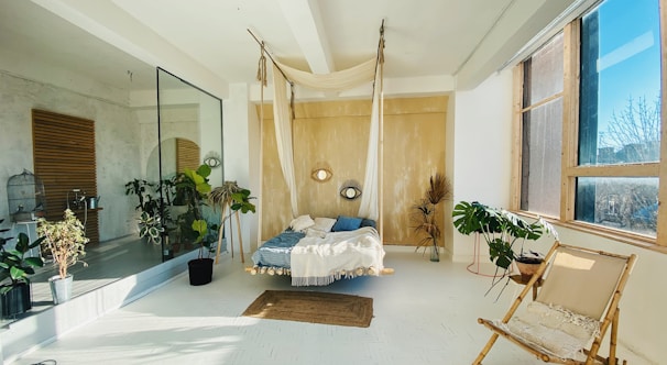 Bright double room with colorful murals and natural decor in a cozy hostel setting.