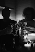 A lively scene of friends clinking glasses at a small table under soft, warm lighting.
