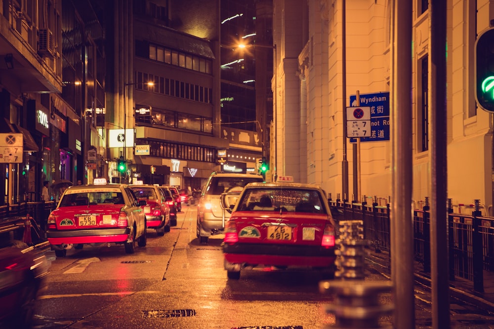 red and white cars on road during night time