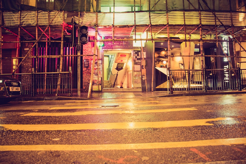 man in white robe standing on sidewalk during night time