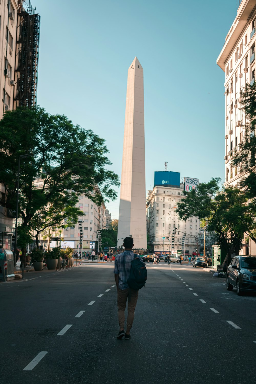 man in black jacket walking on pedestrian lane during daytime