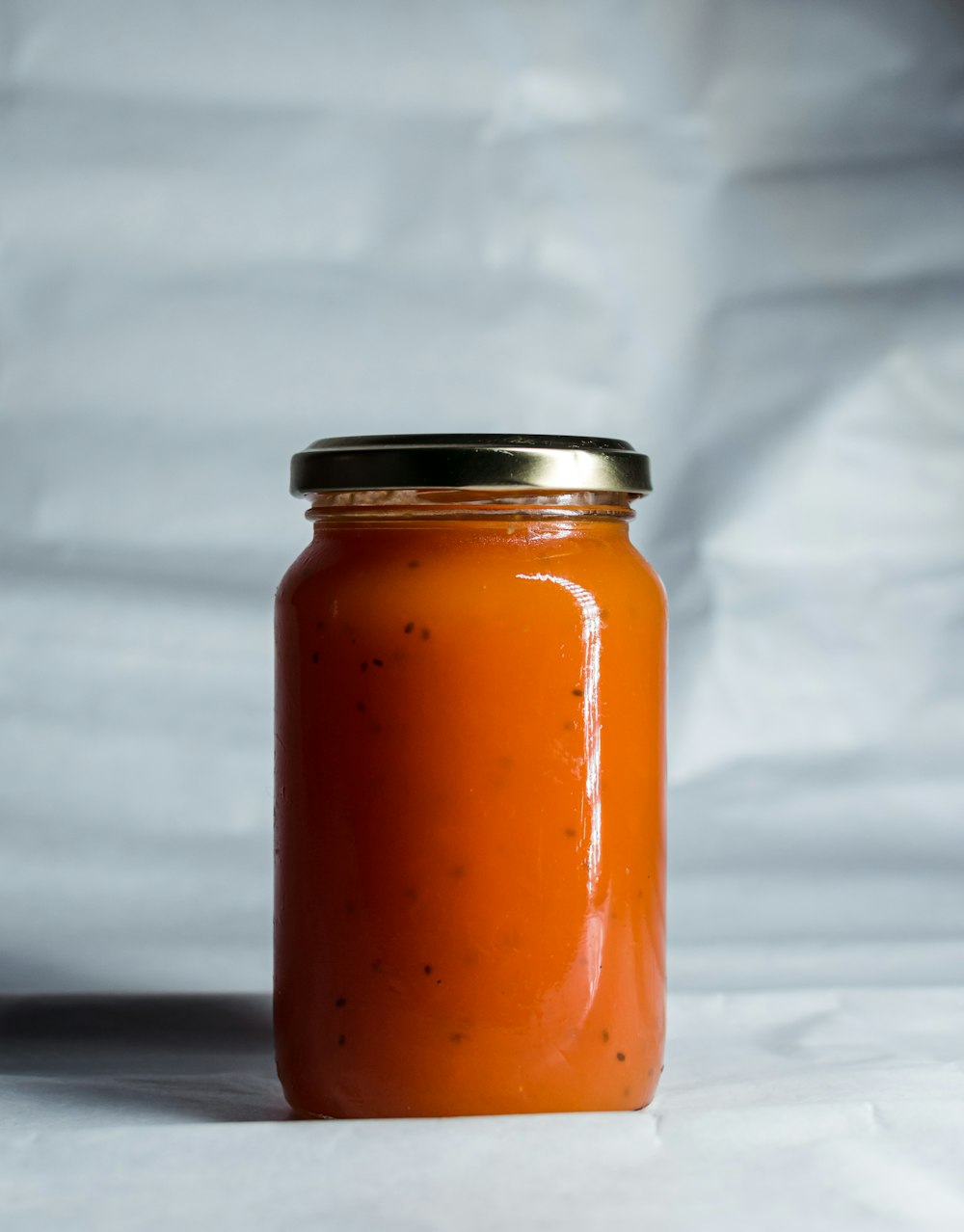 clear glass jar with orange liquid