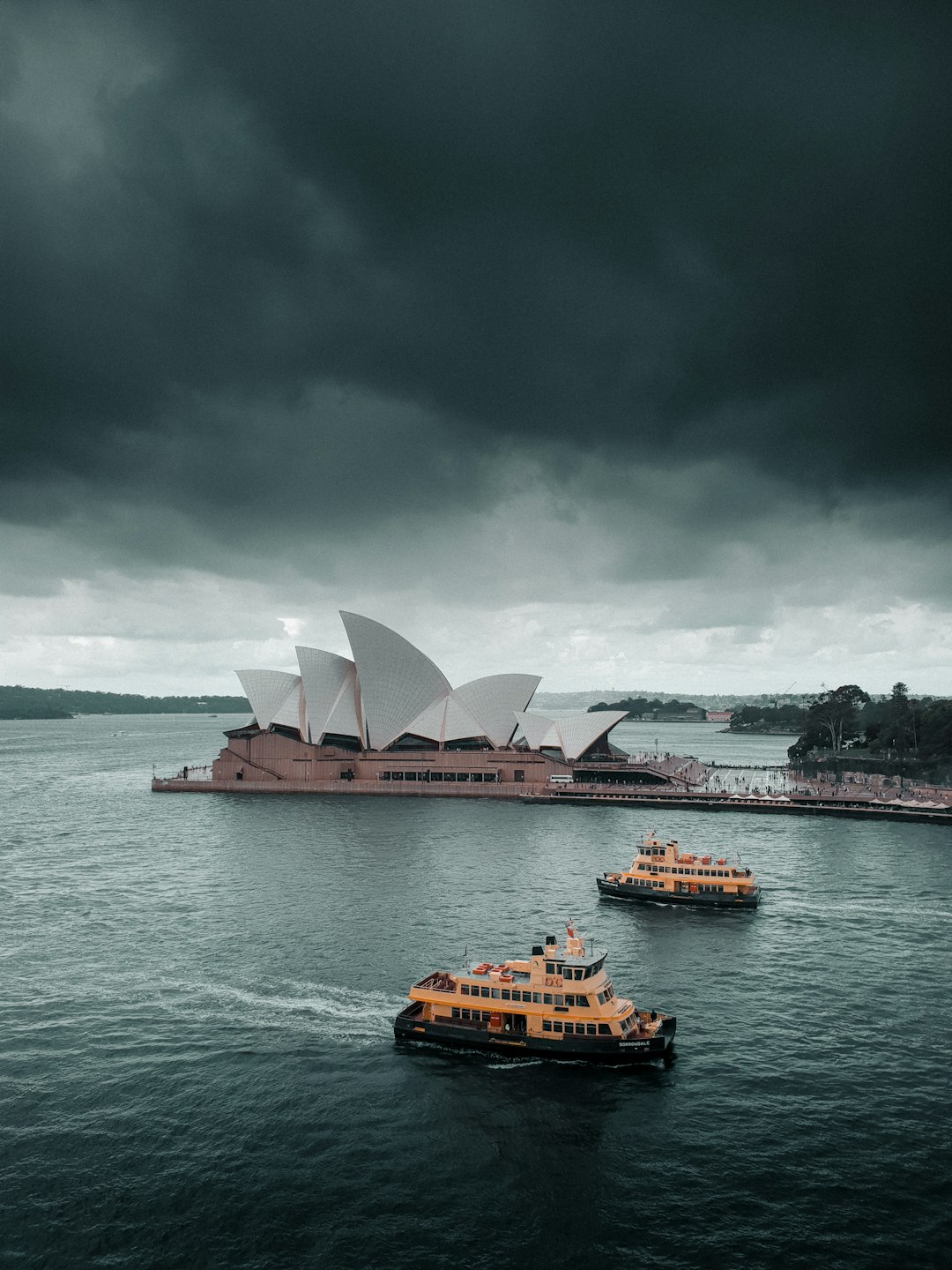 white and red boat on body of water under gray sky