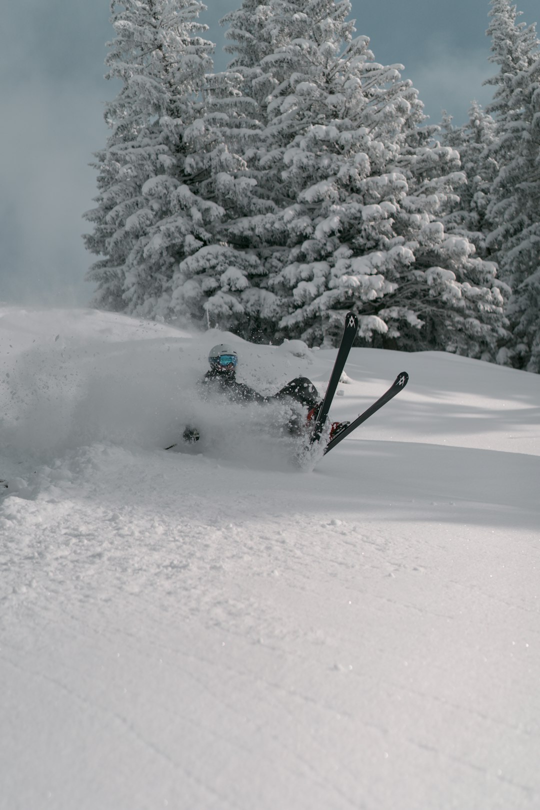 person riding on snow ski board on snow covered ground during daytime