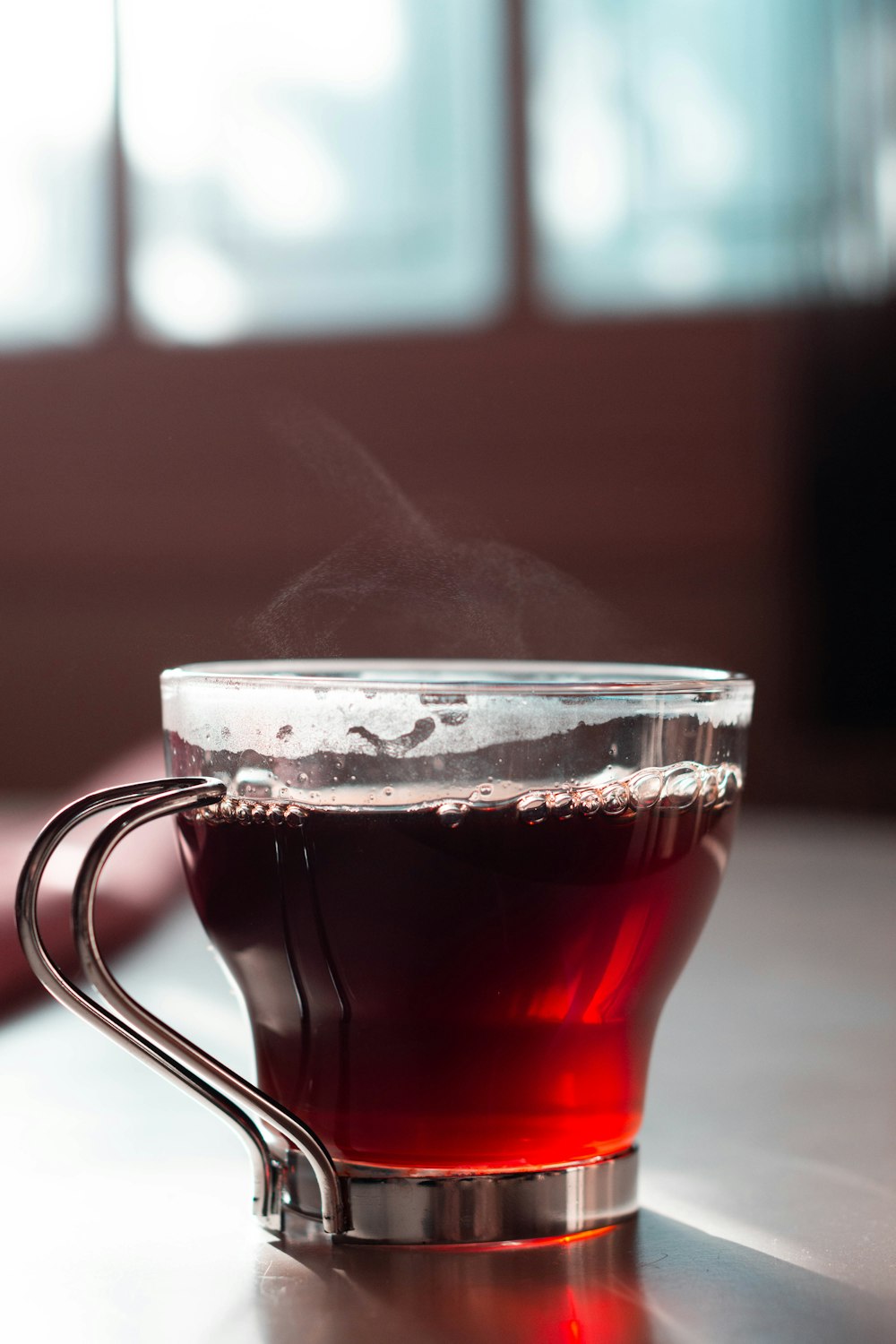 clear glass mug with brown liquid