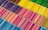 An array of colored pencils arranged in neat, parallel rows, sorted by color. The pencils form a vibrant pattern with a spectrum of shades ranging from cool blues and purples to warm reds, yellows, and greens.