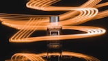 Artistic shot of swirling golden particles representing the scent’s seductive trail in a dark, moody setting.