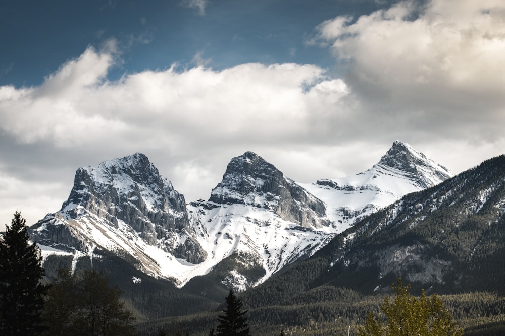 snow covered mountain under cloudy sky during daytime