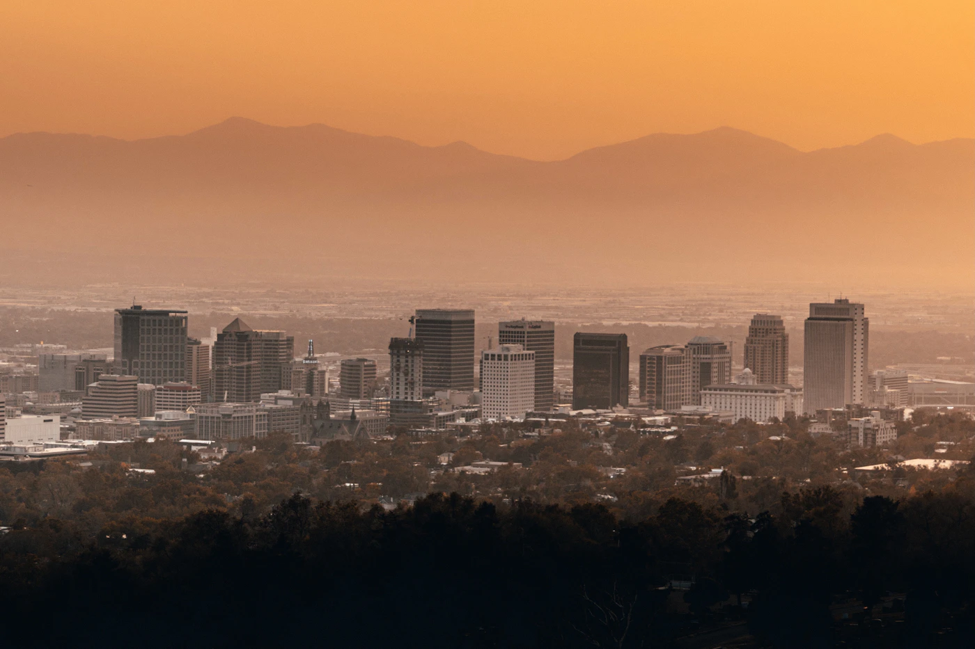 The Salt Lake City skyline at sunset with the mountains rising behind the valley