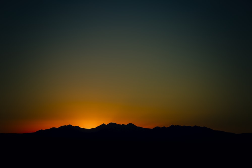 silhouette of mountain during sunset