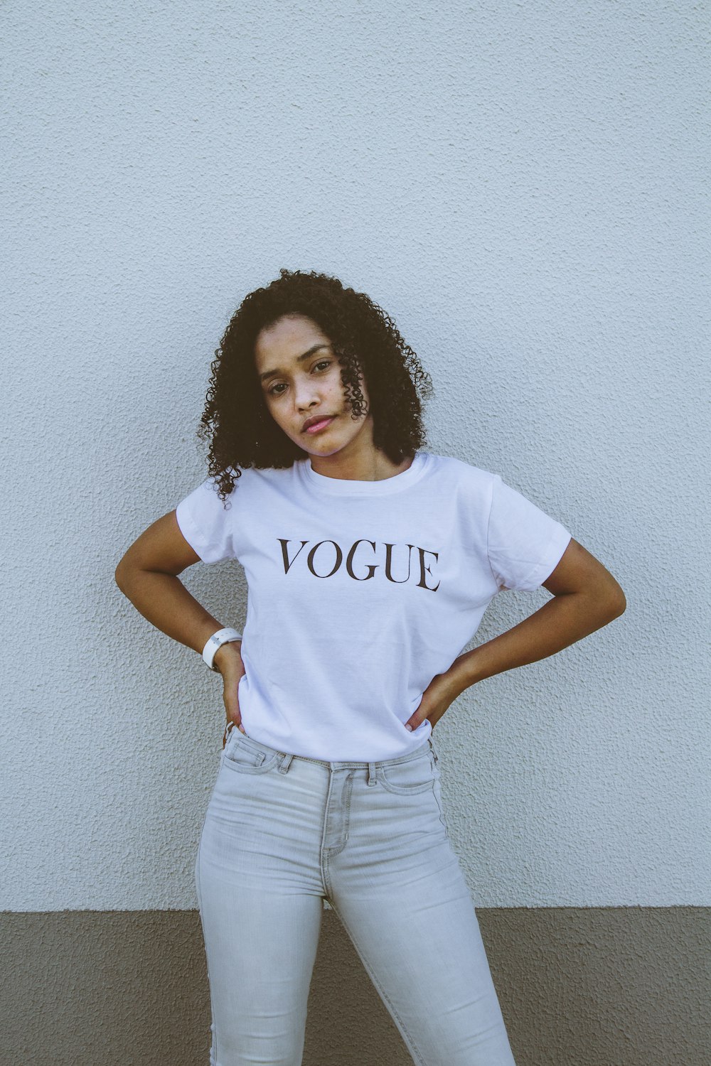 woman in white crew neck t-shirt and gray denim jeans