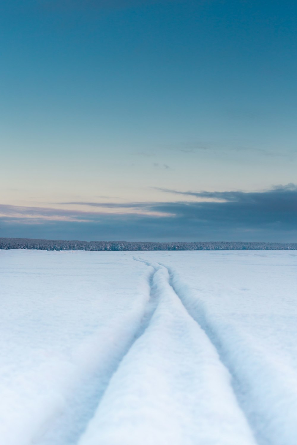 snow covered field under blue sky during daytime