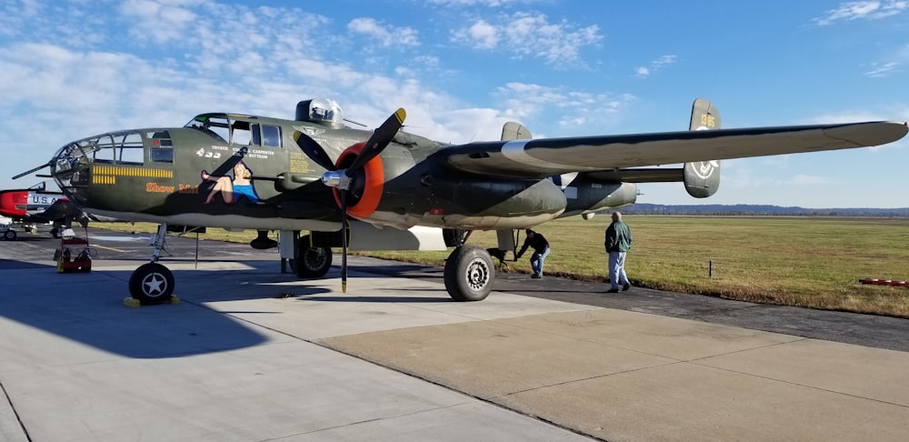 gray and yellow fighter plane on gray concrete ground during daytime