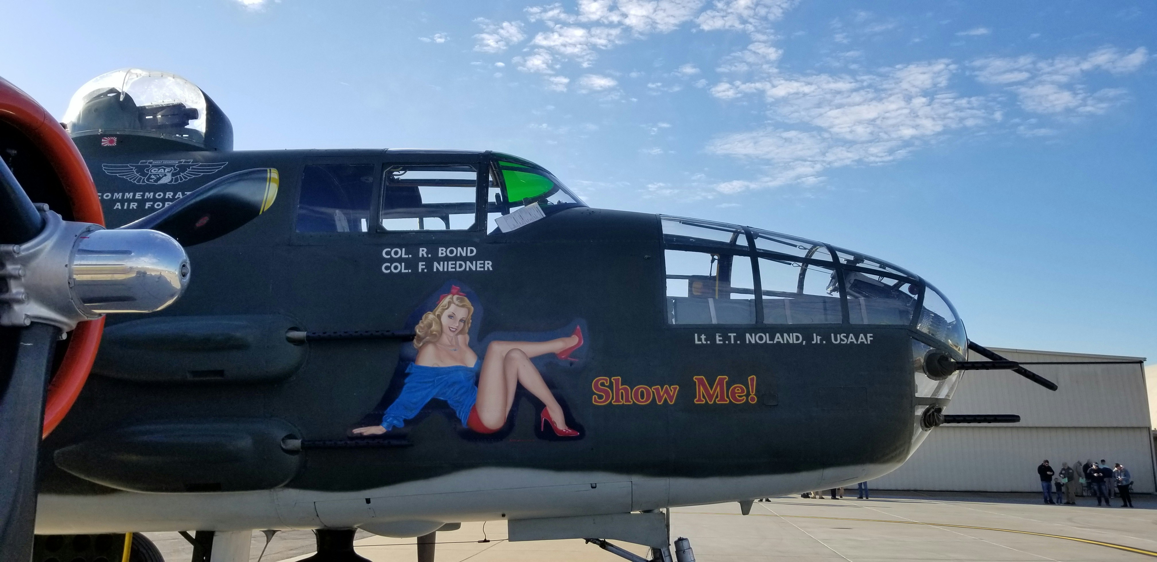 man in blue crew neck t-shirt sitting on blue and white plane under blue and, 