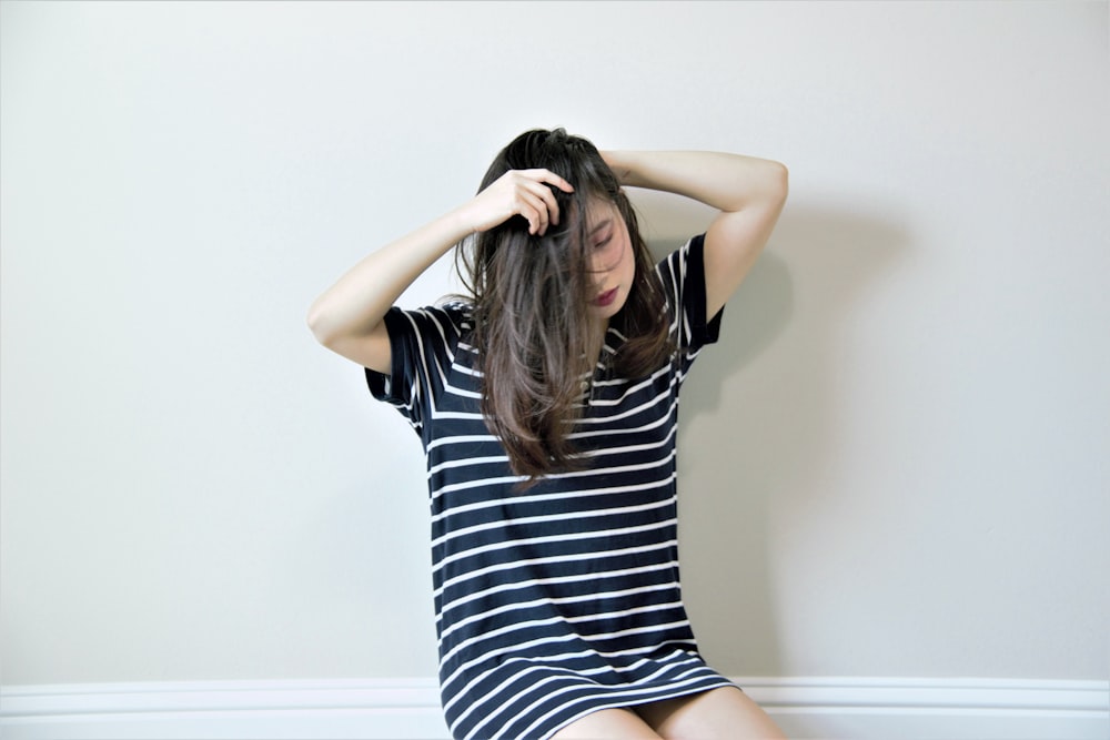 woman in black and white stripe dress