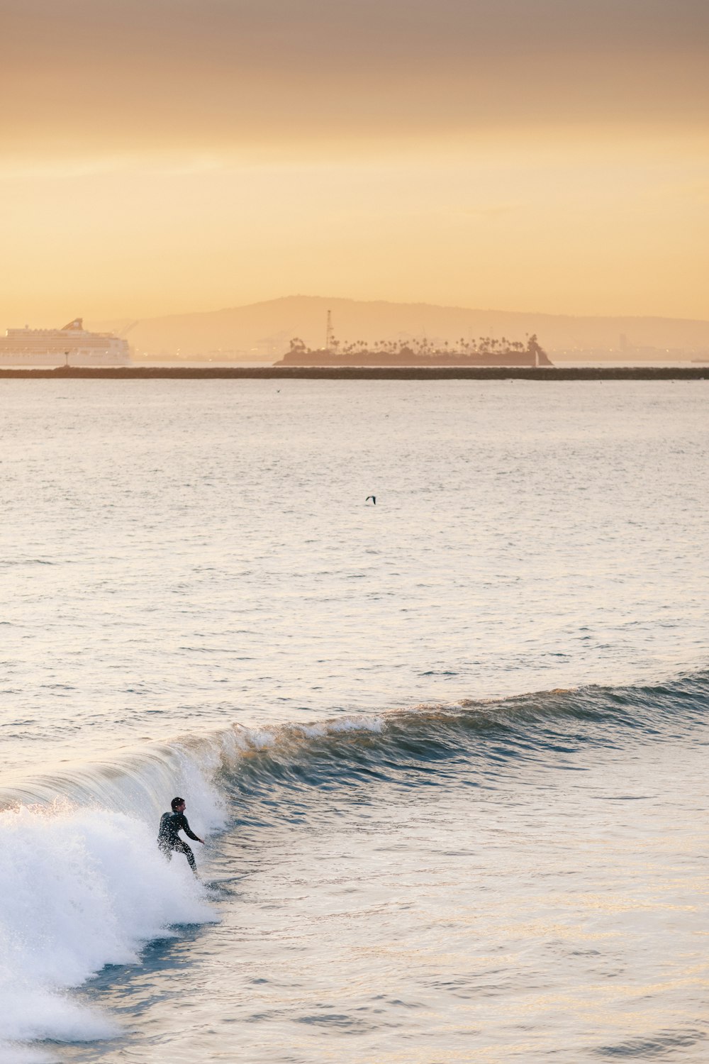 person surfing on sea waves during daytime