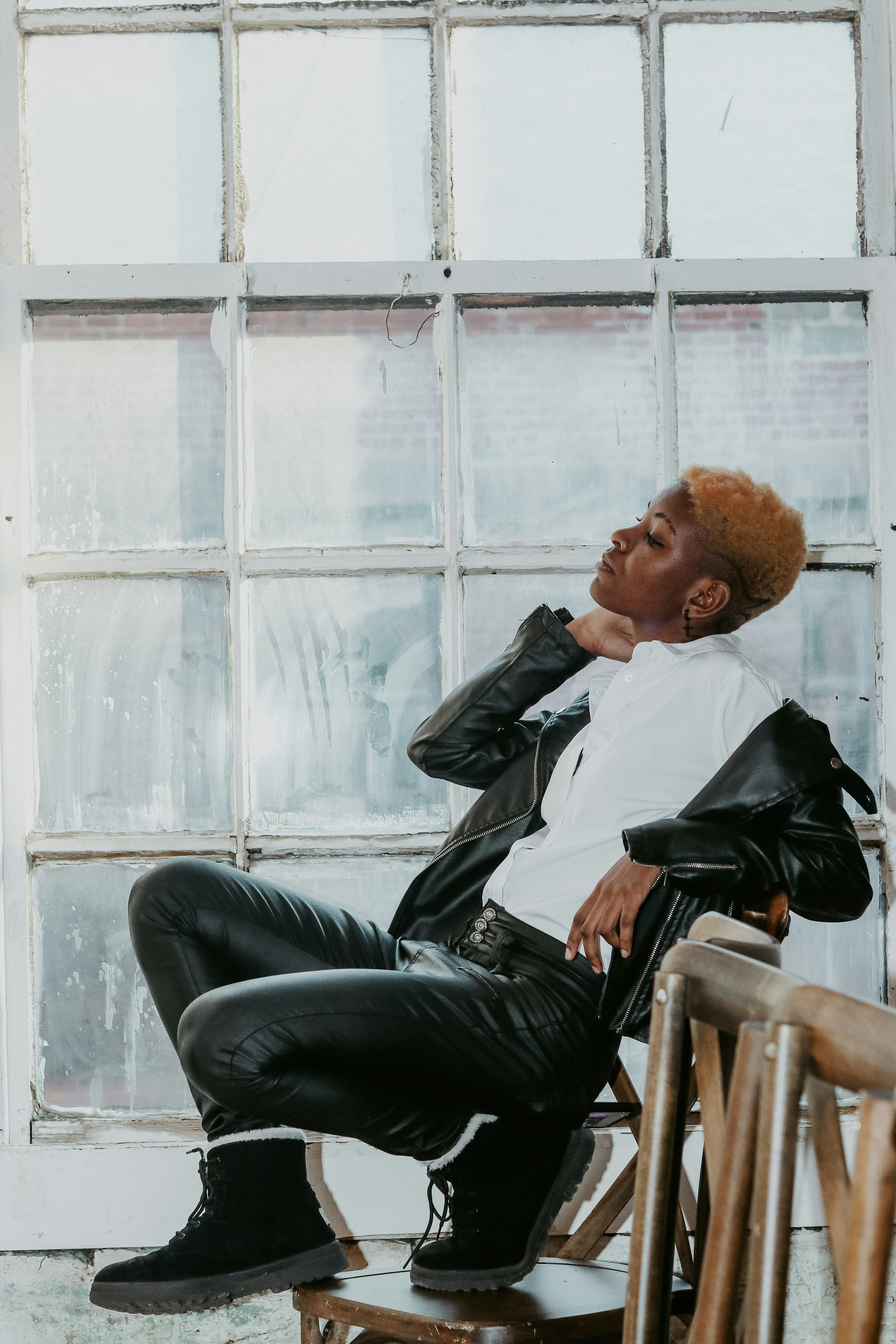 a non-binary person with natural hair with shaved sides