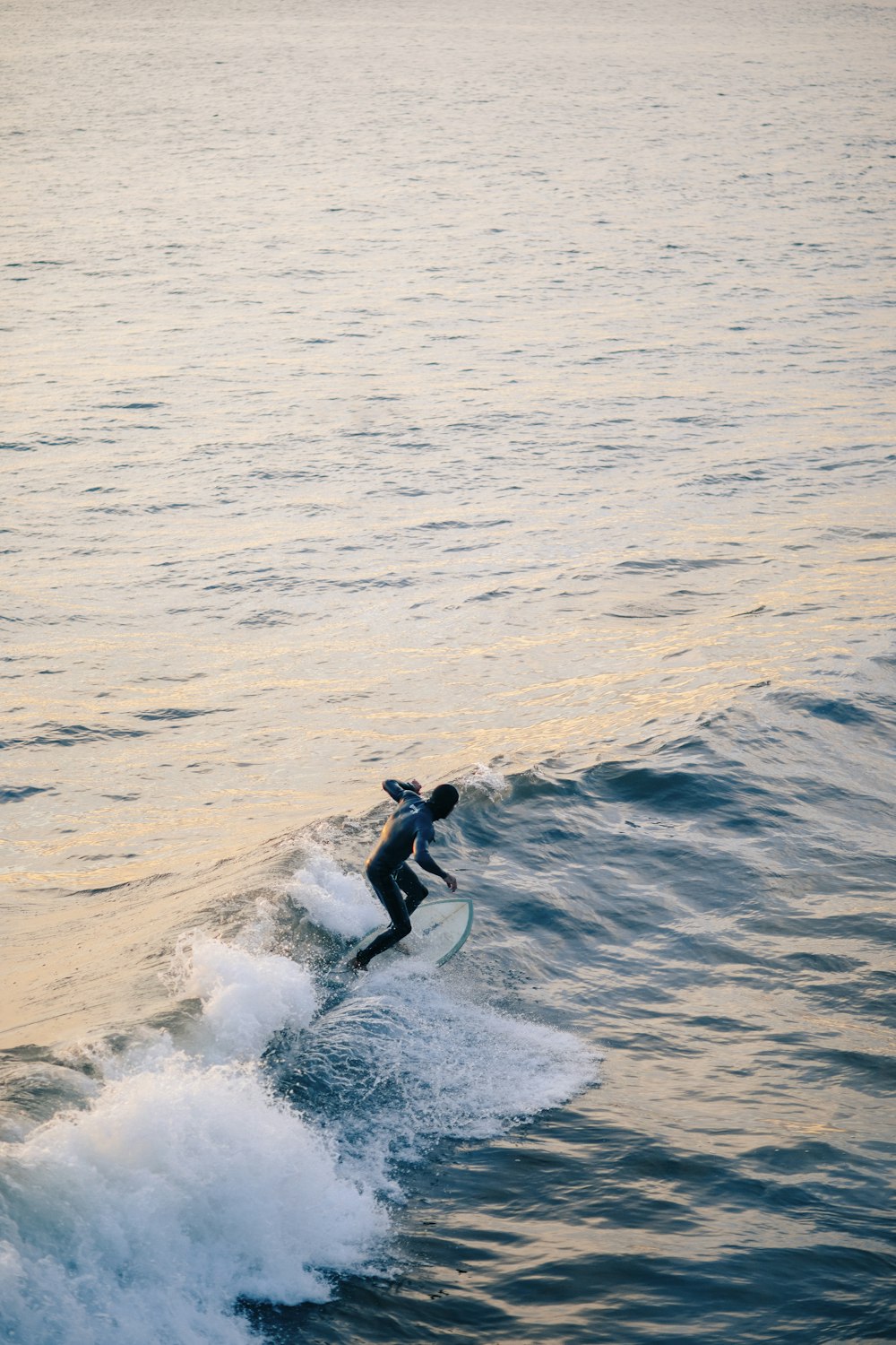 man surfing on sea waves during daytime