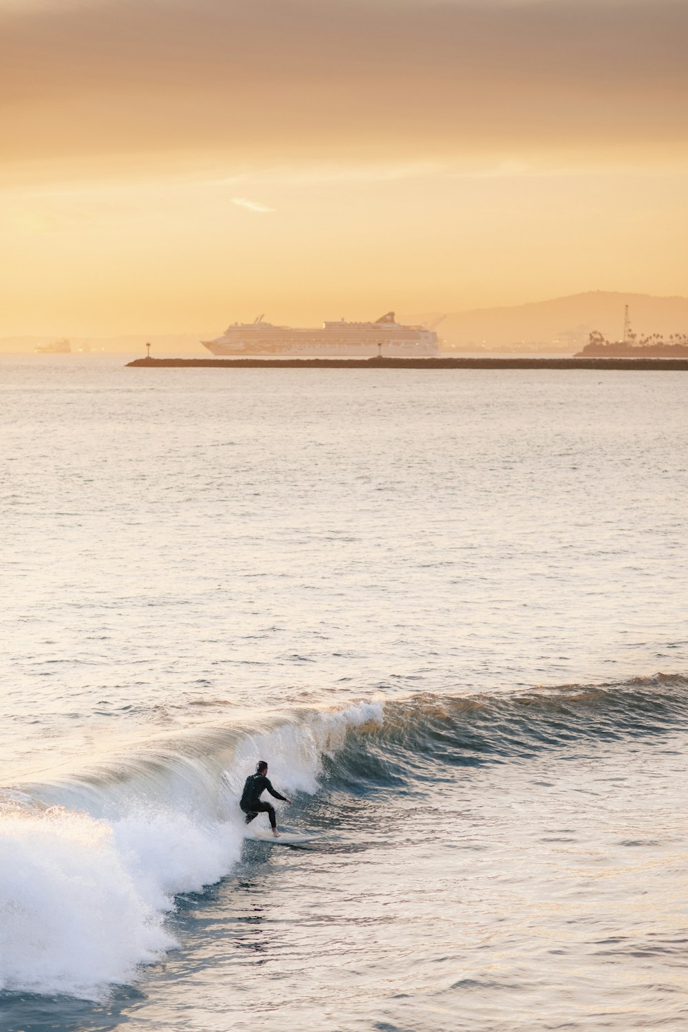 person surfing on sea waves during daytime