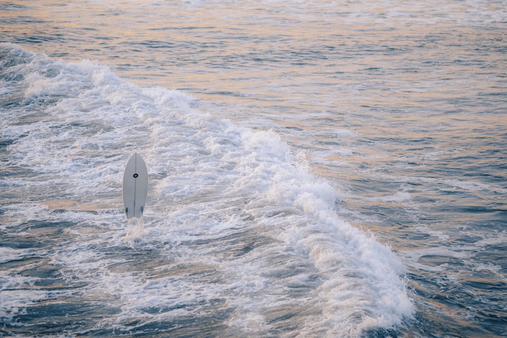 person surfing on sea waves during daytime