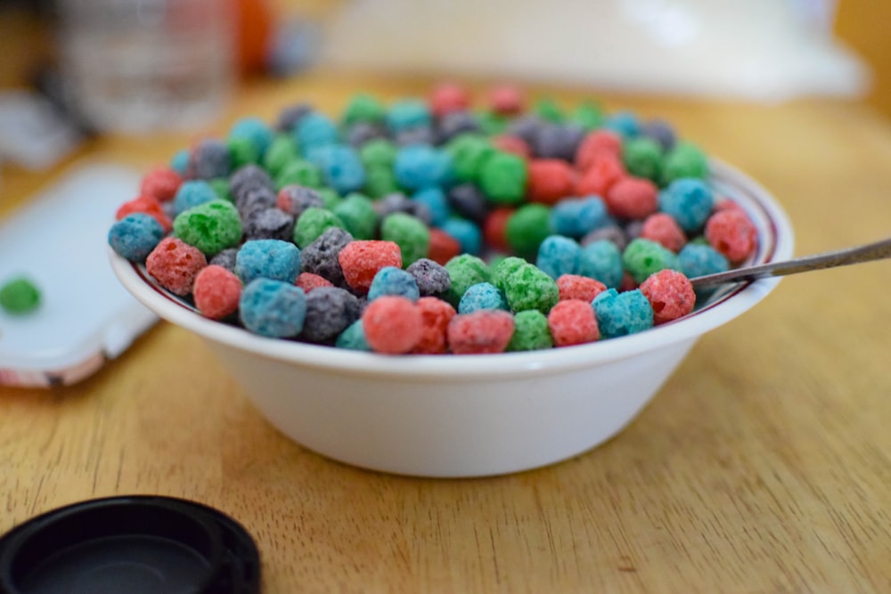 white ceramic bowl with assorted color of beads