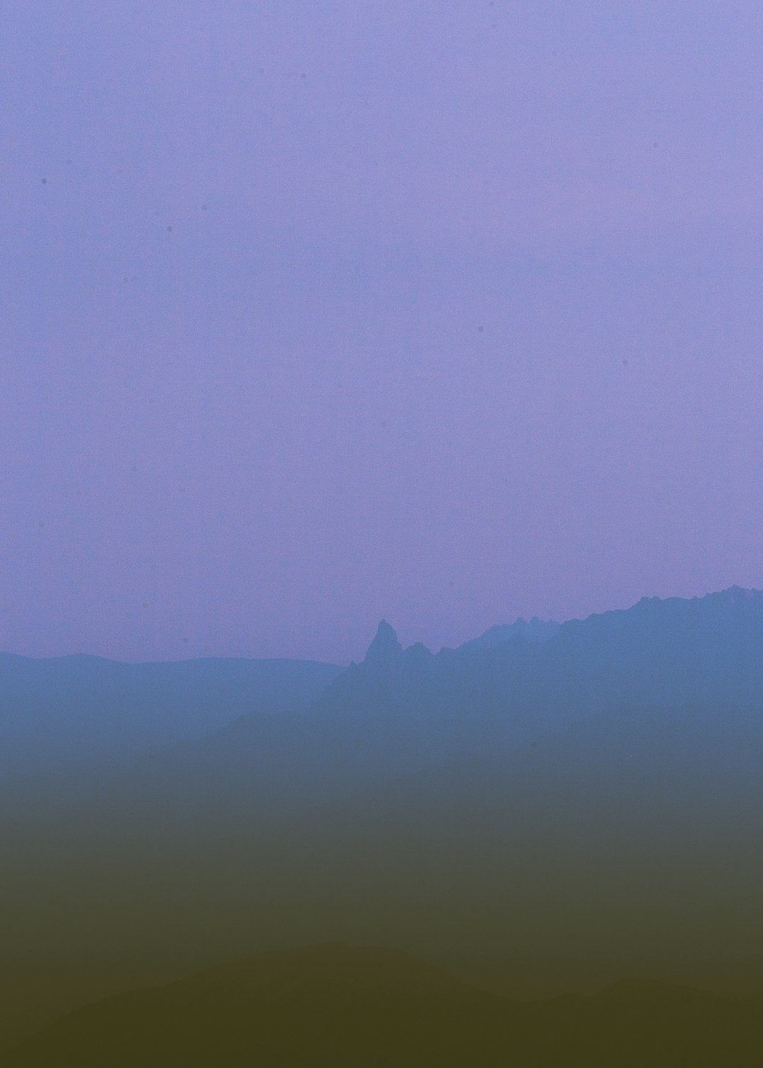 silhouette of mountain during foggy day