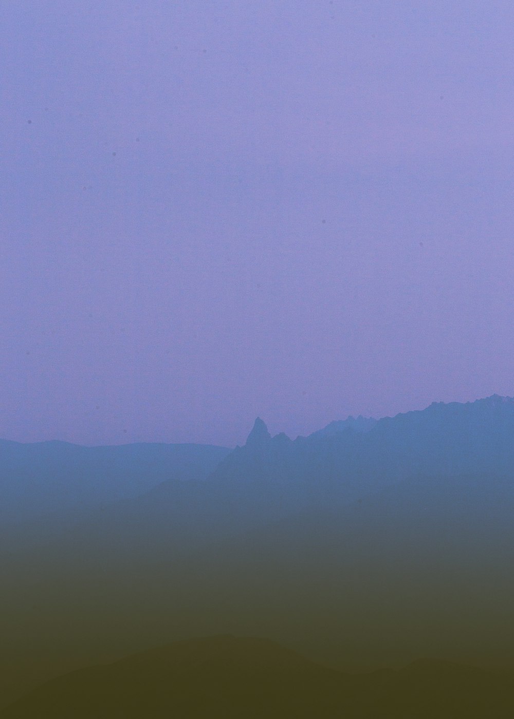 silhouette of mountain during foggy day