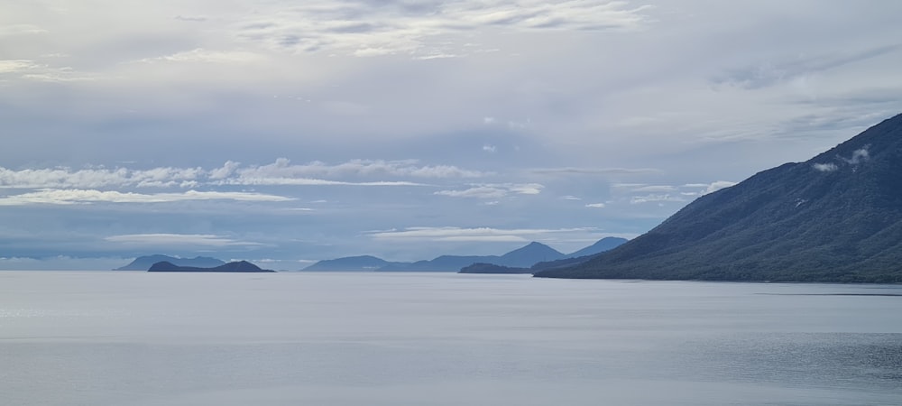 snow covered mountains under cloudy sky during daytime