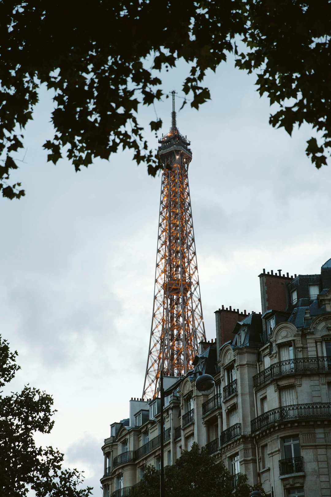 brown and white tower under cloudy sky