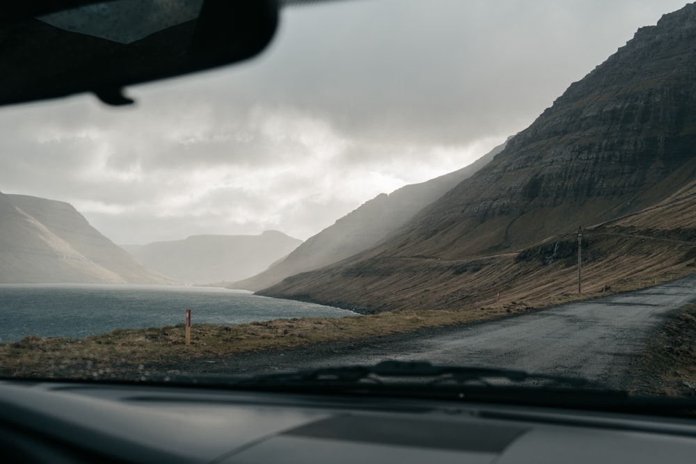 car on road near mountain during daytime