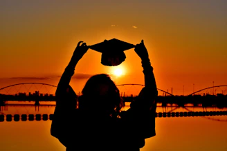 woman in black long sleeve shirt holding heart shaped paper
